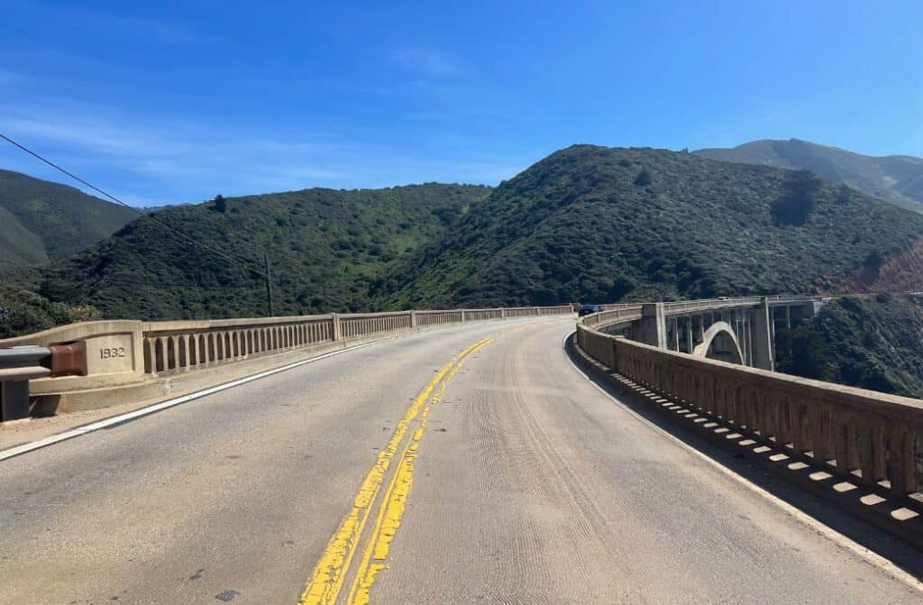 A bridge with mountains in the background.