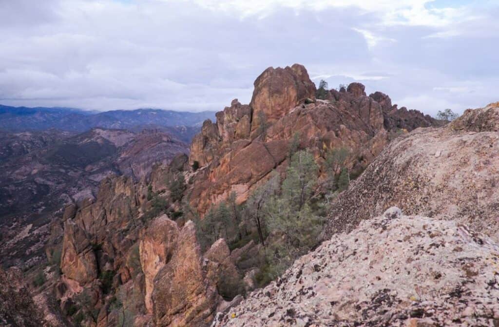 A mountain with trees around in.