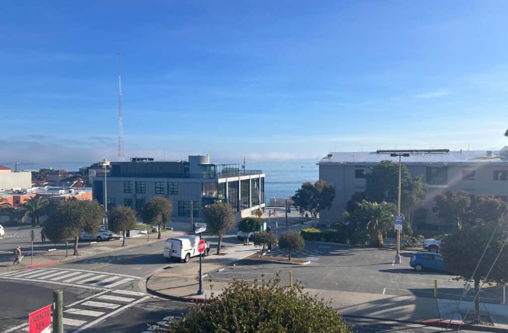 A view of buildings and Monterey Bay, CA.