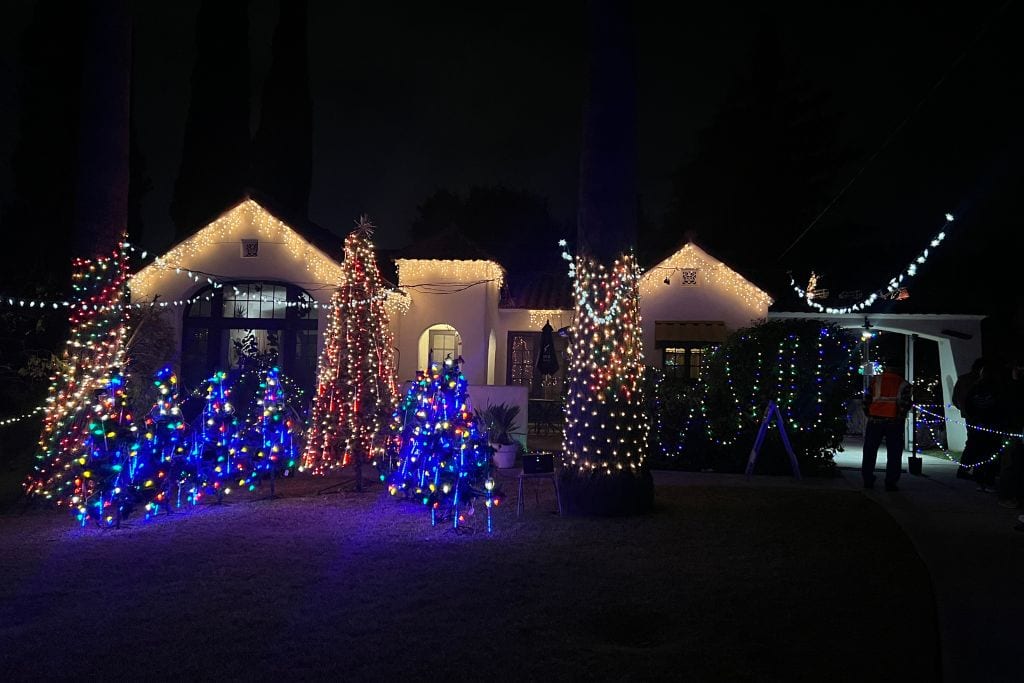 A little house lit with Christmas tree lights