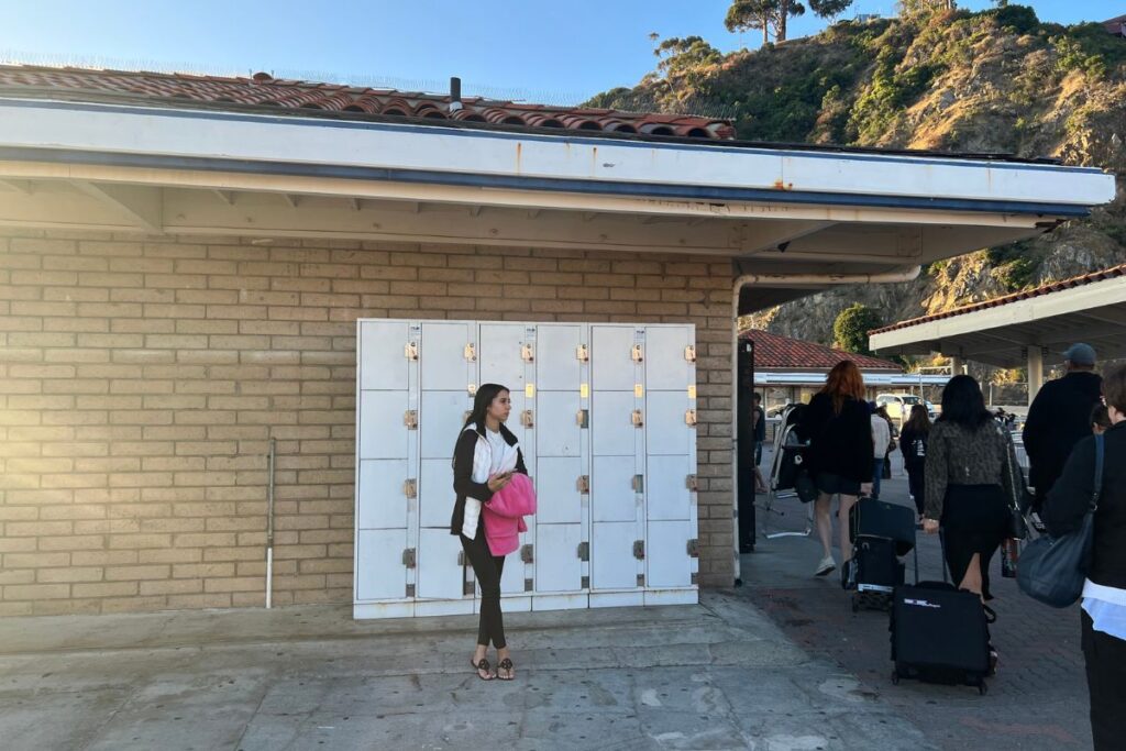 A woman standing in front of white lockers